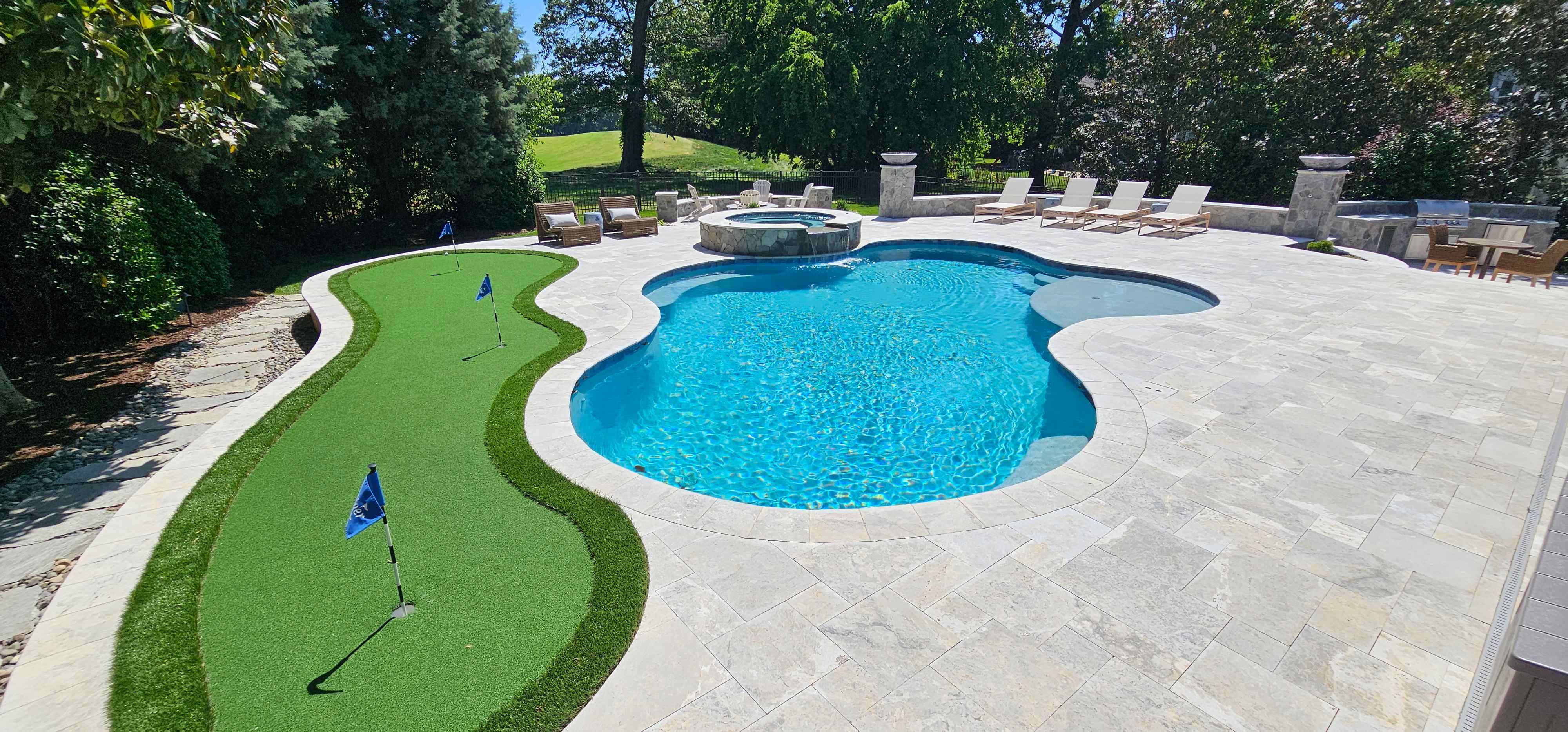 Swimming pool with integrated spa beside the new putting green and poolside entertainment area