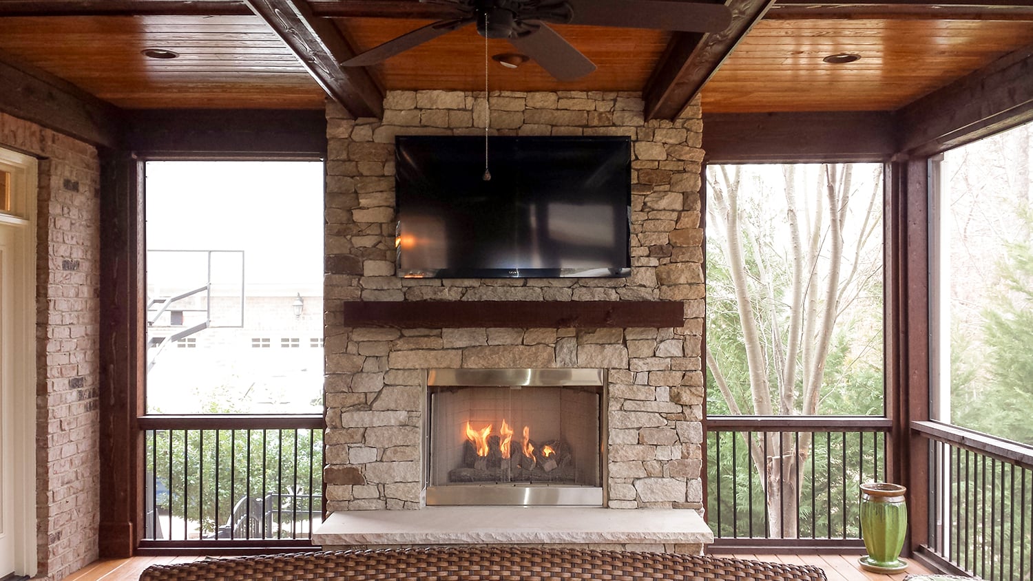 Screened porch in Fort Mill, SC with a floor to ceiling stone fireplace