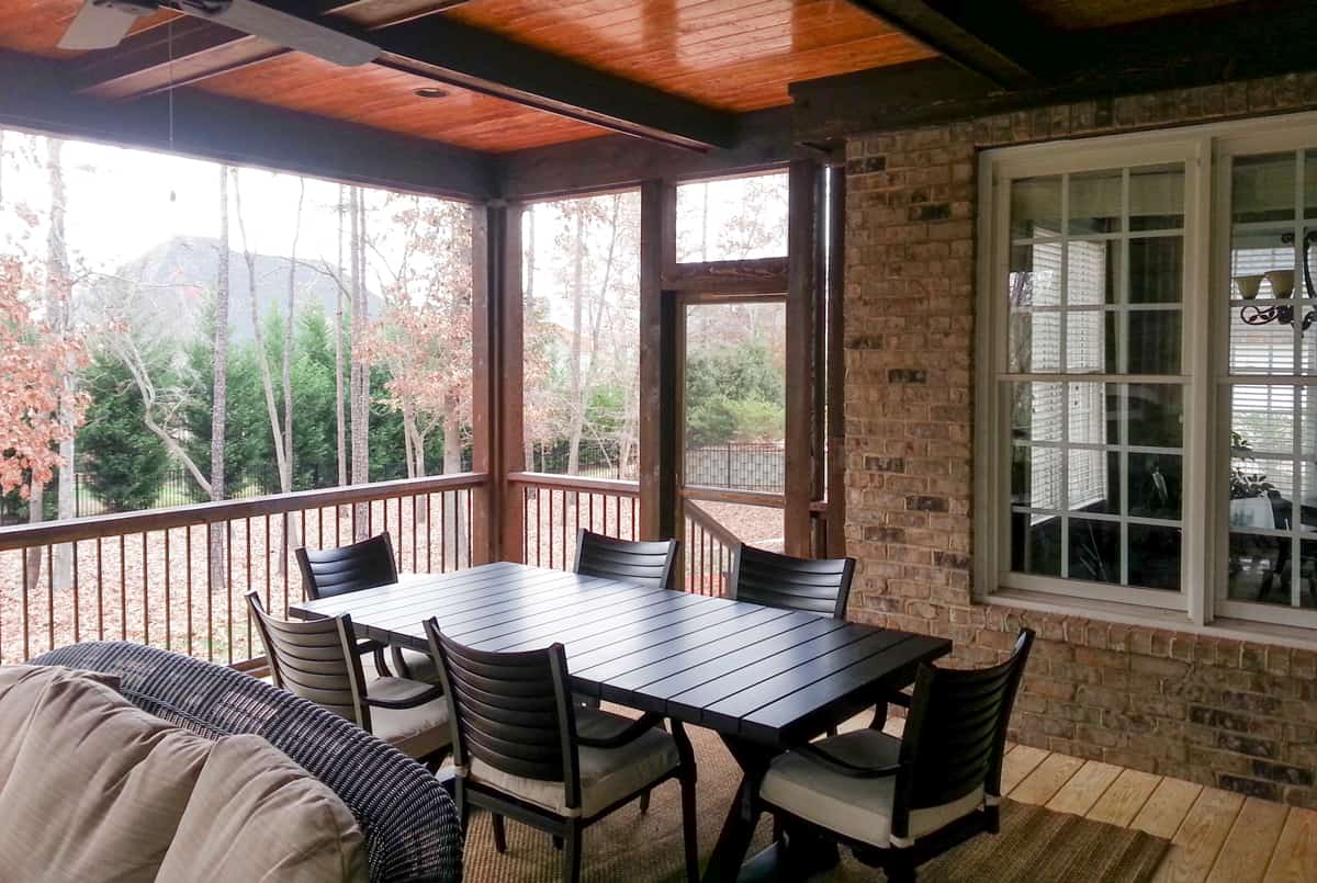 Rustic outdoor living space with exposed wood beams and stone accents